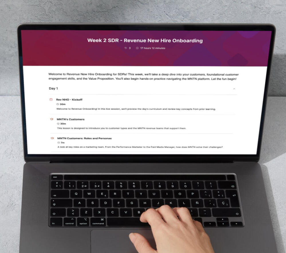 Revenue Enablement Path A learning path pulled up on a laptop screen. It's titled "Week 2 SDR - Revenue New Hire Onboarding".